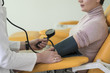 © LStockStudio - Doctor Measuring Blood Pressure