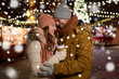 © Syda Productions - winter holidays, hot drinks and people concept - happy young couple with coffee at christmas market in evening