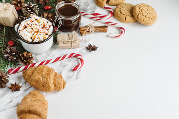 Winter hot drink. Christmas hot chocolate or cocoa with marshmallow, cookies   on white background with christmas decorations. Flat Lay.