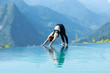 © 220 Selfmade studio - Beautiful Attractive Asian woman practice yoga Downward Facing Dog or Adho Mukha Svanasana pose on the pool above the Mountain peak in the morning in front of beautiful nature views in SAPA vietnam