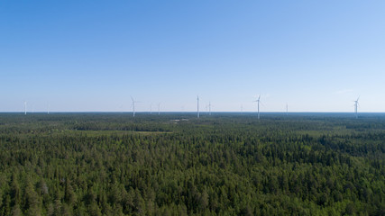 Aerial view of Windmills for electric power production on the forest. FInland