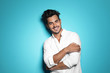 © New Africa - Young man with trendy hairstyle posing on color background
