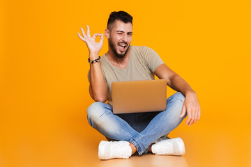 Portrait of a happy young casual man sitting