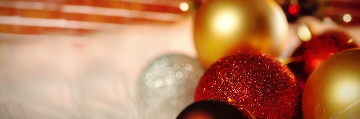 Poster - Composite image of colored christmas ornaments on carpet
