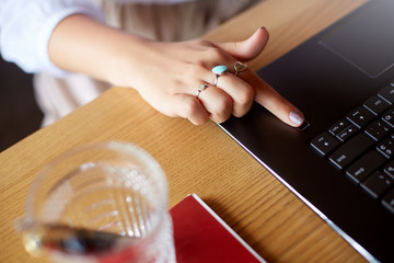 Wall Mural - close up photo of woman touching laptop fingerprint sensor with her finger to log in into system. bi