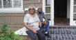 © Mark Adams - Happy retired black couple sitting outdoors