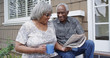 © Mark Adams - Happy retired African American couple reading newspaper