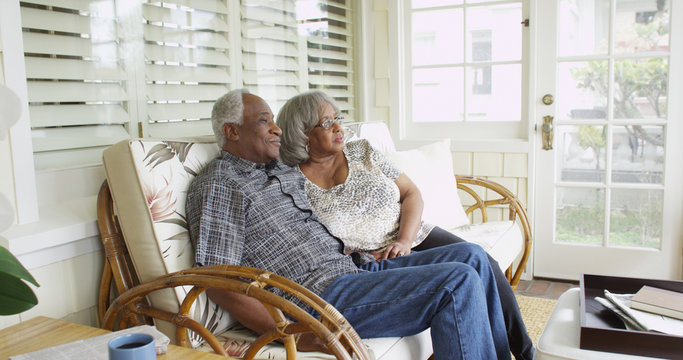 Wall Mural -  - Mature black couple sitting on couch looking away