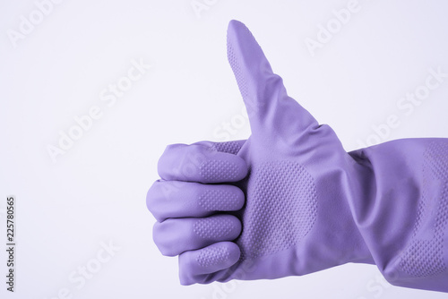 Fotografia, Obraz Close up view of human hand with rubber domestic violet glove showing ok or approve sign with thumb up, isolated on white background