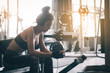 © wutzkoh - Healthy asian woman relaxing and exercise with listen music after the workout at gym.