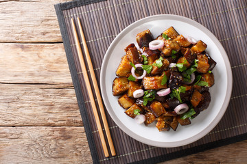 Spicy Sichuan eggplant is also known as fish fragrant eggplant (Yu Xiang) closeup on a plate. Horizontal top view