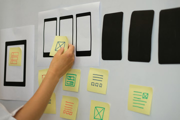 user experience ux designer designing web on smartphone layout. ui planning mobile application. deve