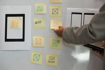 user experience ux designer designing web on smartphone layout. ui planning mobile application. deve