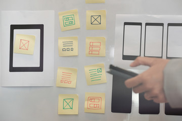 user experience ux designer designing web on smartphone layout. ui planning mobile application. deve
