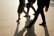© DragonImages - Team of business peole walking outdoors after day of work