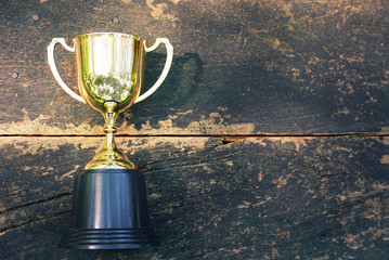 Wall Mural - topview sunlight on trophy on wood table