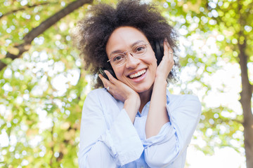 Wall Mural - Beautiful Happy Afro American Young Woman Listening Music In Nature