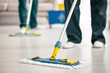 © Photographee.eu - Close-up on mop on the floor holding by cleaning specialist while purifying interior