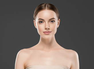 Wall Mural - beautiful woman face skin closeup portrait over gray background with healthy skin and hair