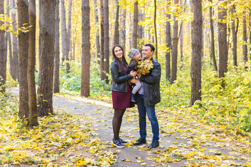 Wall Mural - Parenthood, fall and people concept - young family happy in autumn park