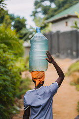 Woman carrying water in Uganda, Africa