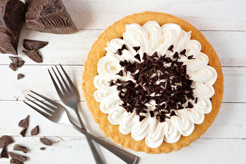 Poster - Delicious chocolate cream pie. Top view table scene on a white wood background.