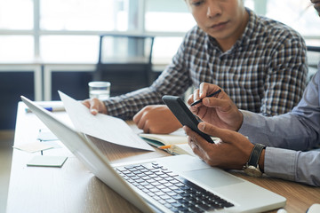 developer with smartphone and stylus testing application interface
