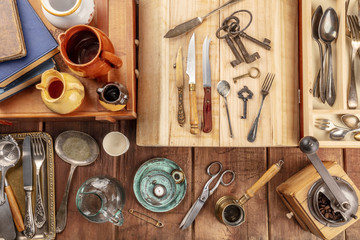 Wall Mural - An overhead photo of many vintage objects, flea market stuff on a wooden background