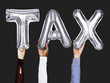 © Rawpixel.com - Hands showing tax balloons word