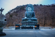Big Buddha Statue In Seoraksan National Park In South Korea, Surround Background Mountain In Winter Season. For Use To Background,wallpaper,template.