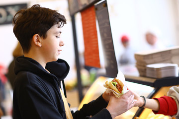 Wall Mural - teenager boy on vegan food court close up photo