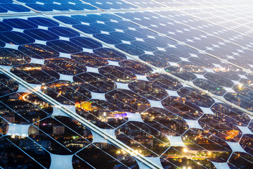 texture of photovoltaic panels solar panel with city night light background, alternative energy conc