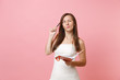 © ViDi Studio - Pensive bride woman in wedding dress searching ideas for planning wedding, writing notes in diary, notebook isolated on pastel background. Wedding to do list. Organization of celebration. Copy space.