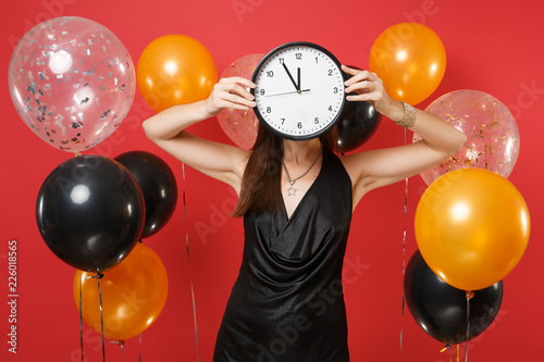Young Woman In Black Dress Covering Face With Round Clock On Bright Red Background Air Balloons Time Is Running Young Woman In Black Dress Covering Face With Round Clock On Bright Red Background Air Balloons Time Is Running