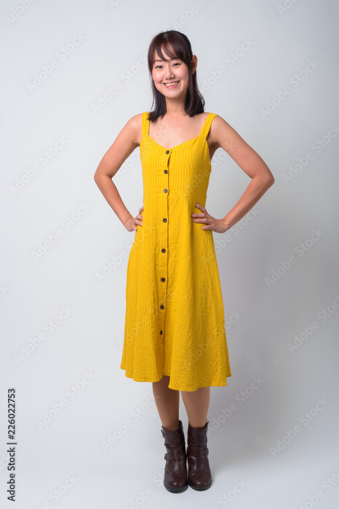 Portrait of beautiful Asian woman wearing yellow dress Stock Photo ...