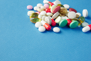 Canvas Print - Pills are scattered over a blue background