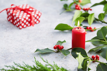 Wall Mural - christmas decorations, candle and holly leaves with red berries.