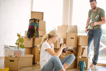 Couple Taking A Picture wwith old film camera In New Home