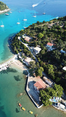 Wall Mural - Aerial drone bird's eye view photo of iconic small port and fishing village of Lakka with traditional Ionian architecture and sail boats docked, Paxos island, Ionian, Greece