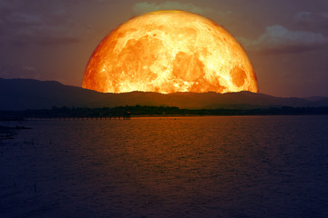 Wall Mural - blood moon back on mountain and light reflection on lake