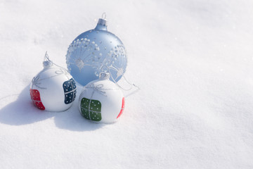 Christmas decorations on white snow in sunny day