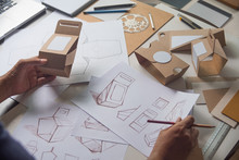 Designer Sketching Drawing Design Brown Craft Cardboard Paper Product Eco Packaging Mockup Box Development Template Package Branding Label . Designer Studio Concept .
