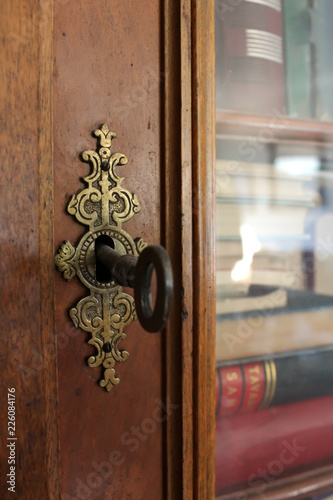 Old Lock And Key On Antique Bookshelf With Glass Doors Buy This
