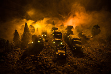 War Concept. Military silhouettes fighting scene on war fog sky background, World War Soldiers Silhouettes Below Cloudy Skyline At night. Attack scene. Selective focus Tanks battle. Decoration