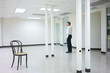 © Paul - Businessman standing in empty bright office and look out thinking