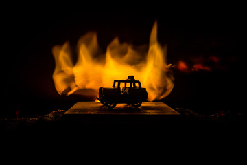 Wall Mural - Off roader jeep silhouette on dark toned foggy sky background. Car with light at night.