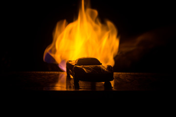 Wall Mural - The car in the shadows with glowing lights in low light, or silhouette of sport car dark background.