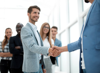 two young people shake hands