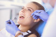 © lenets_tan - Young Female patient with open mouth examining dental inspection at dentist office.