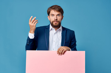 a man with a beard holding a pink background, a free place